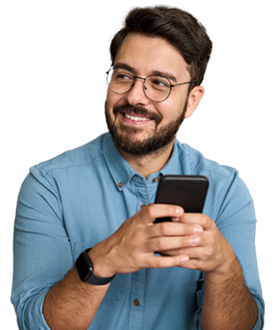 A man smiling while looking on his phone
